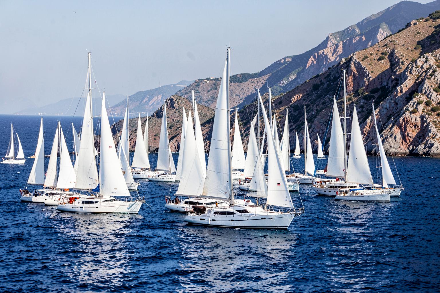 A fleet of Swan sailing yachts racing in the waters near Porto Cervo.